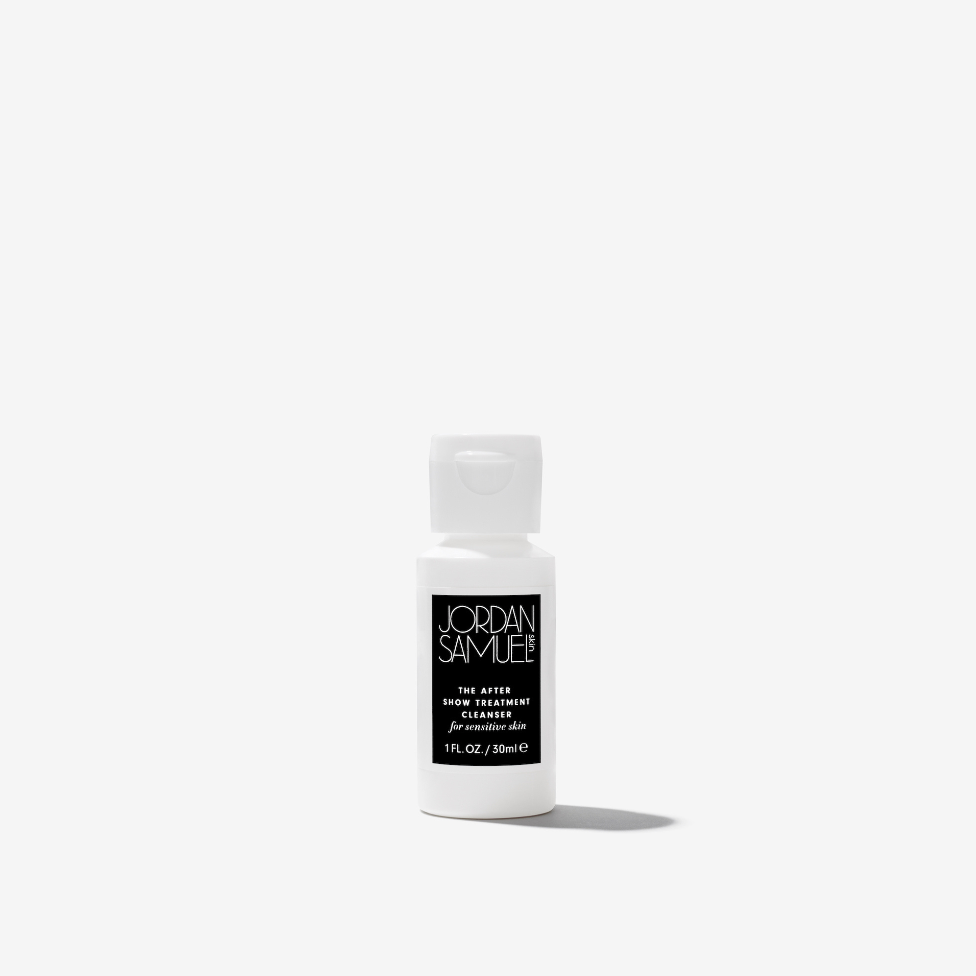 The After Show Treatment Cleanser for Sensitive Skin mini product image - White squeeze bottle with black label on a white background